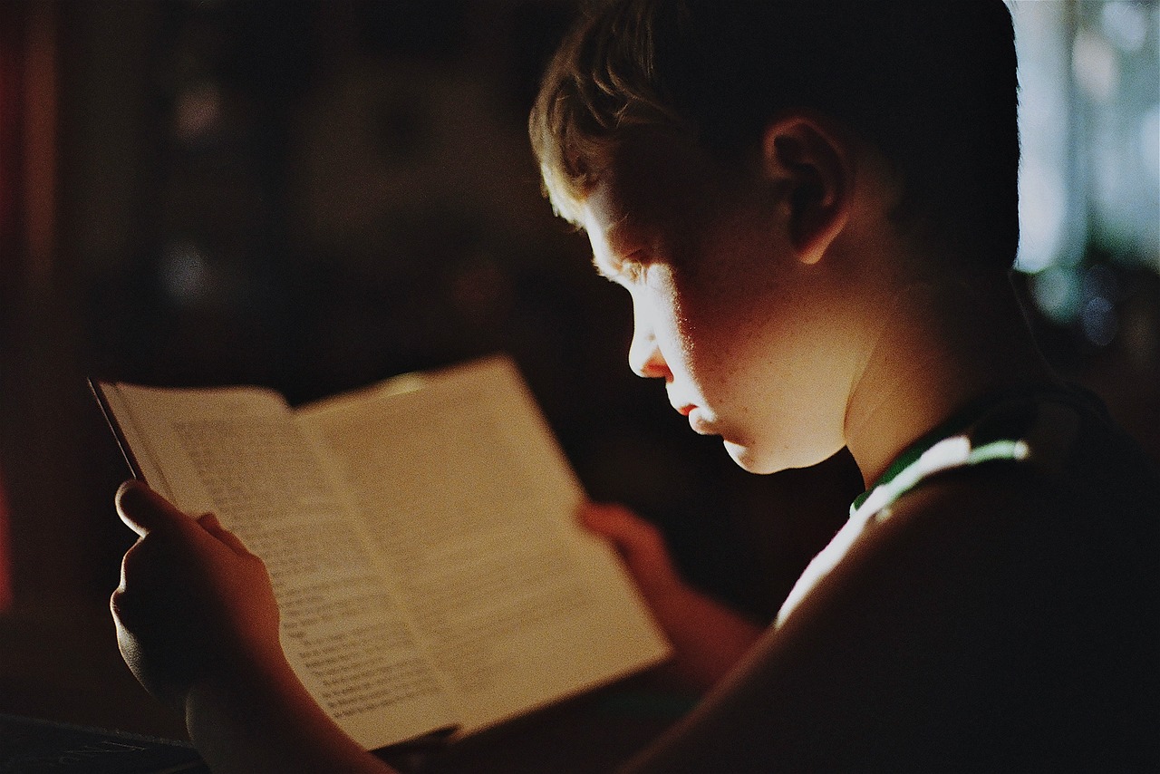 little boy reading a book